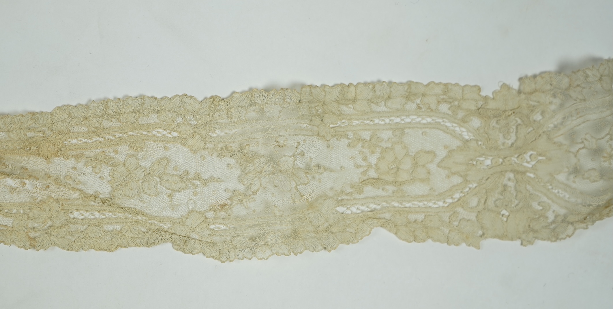 A 19th century Brussels Point de Gaz needle lace collar, lappet and wedding hankie, possibly part of a trousseau. The collar having thirty four needle lace raised flower heads within the design. The collar 100cm long x 1